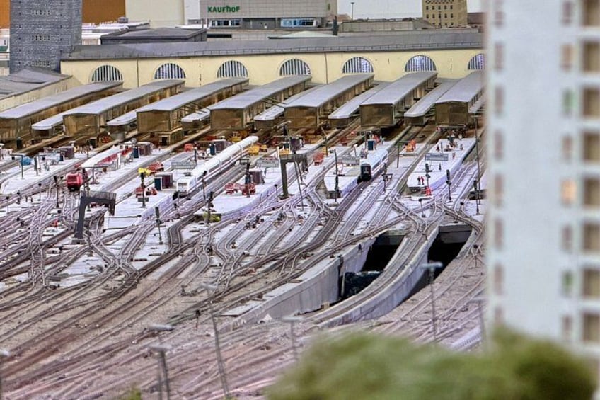 A complex railway station with multiple tracks and platforms. 4