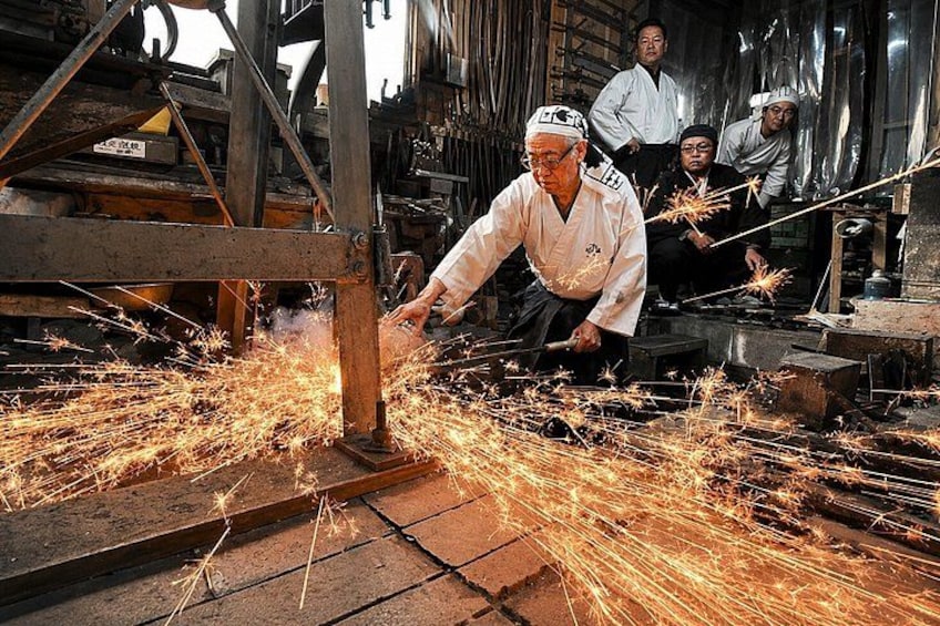 A person welding with sparks flying, surrounded by metal structures and machinery. 1