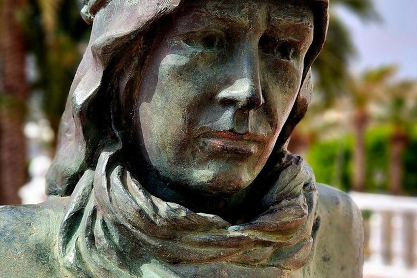 A bronze statue with a draped garment. 3