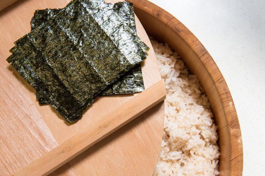 Seaweed sheets and rice on a wooden board. 2