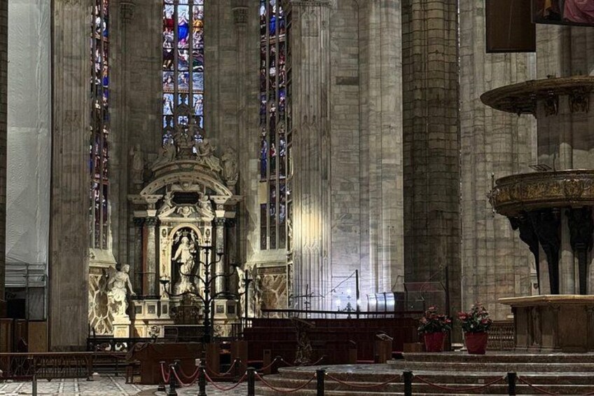 A grand cathedral interior with a central altar, stained glass windows, and a large fountain. 3