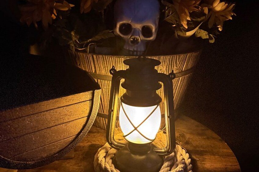 A lantern with a skull in the background. 3