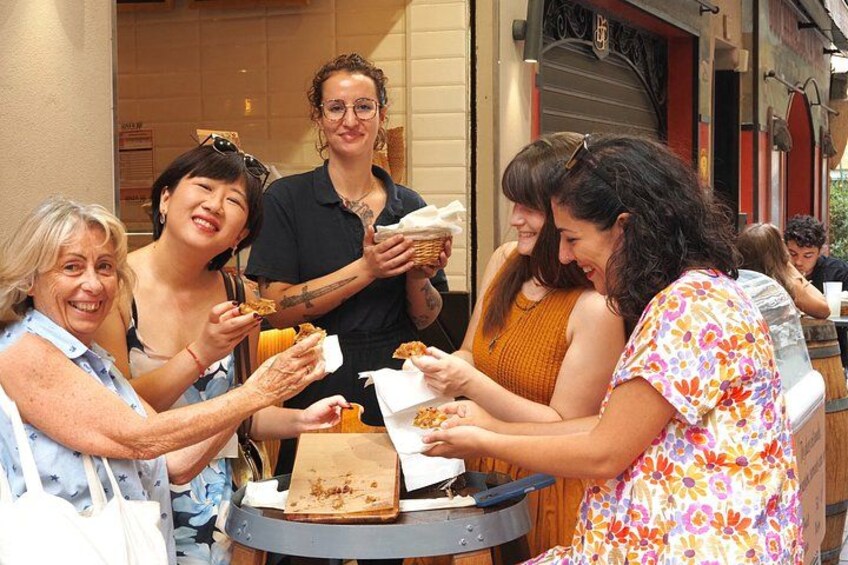 A group of people eating at an outdoor table. 1