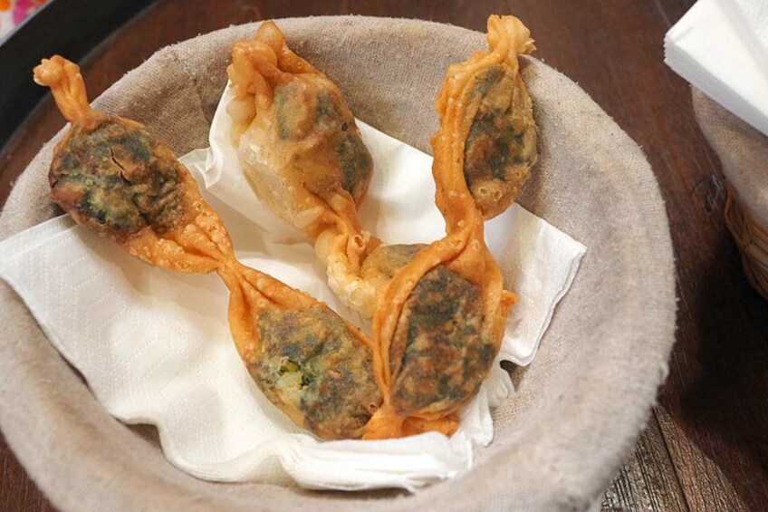 A plate of fried dumplings with a crispy exterior. 2