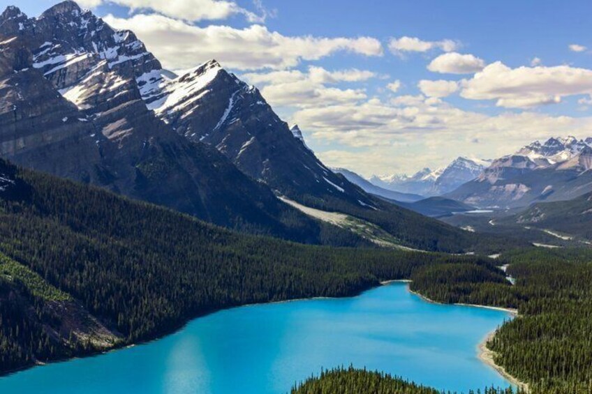 A mountain range, a turquoise lake, and dense forest. 3