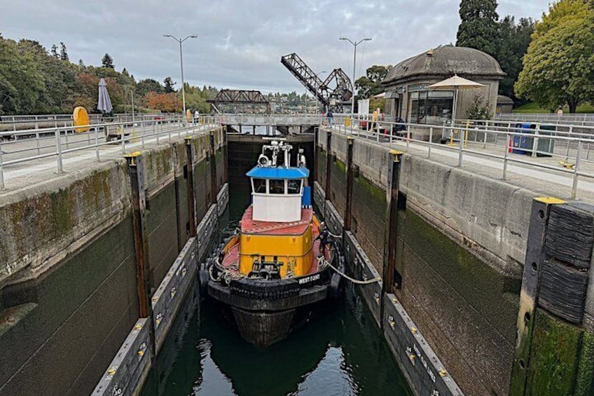 A narrow waterway with a tugboat navigating through a lock system. 3