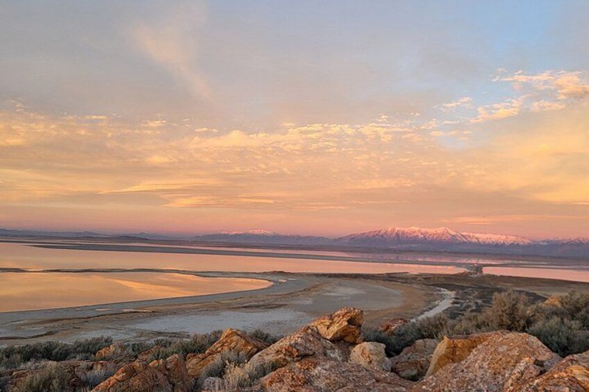 A vast salt flat landscape with a distant mountain range and a clear sky. 3