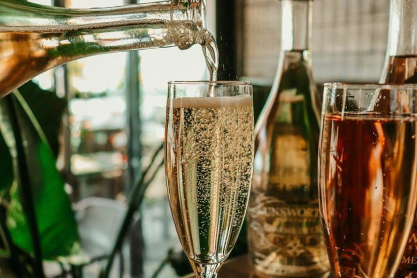 A champagne bottle being poured into a glass. 2