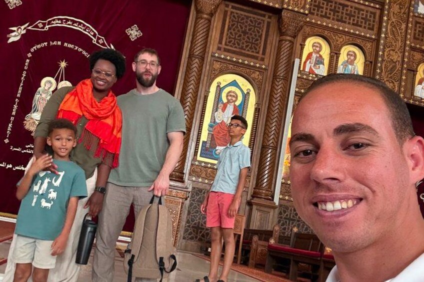 A group of people in a church with ornate decorations and religious icons. 3