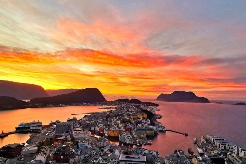 A coastal town at sunset with a calm sea, a prominent ship, and distant mountains. 3