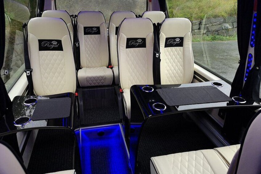 A vehicle interior with six cream-colored seats, each with a 'Royal' logo. 4