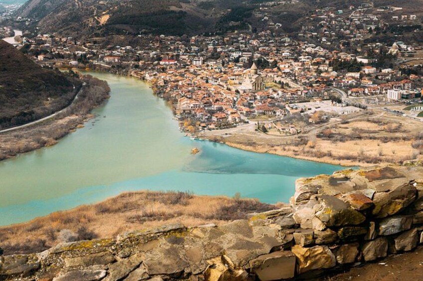 A river winding through a town with buildings and a prominent church. 4