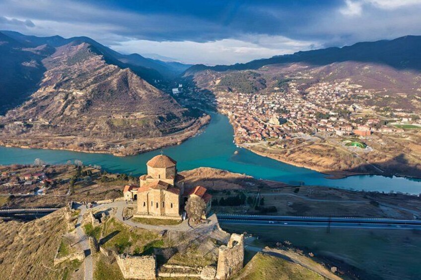A historic church, a river, and a mountainous landscape. 5