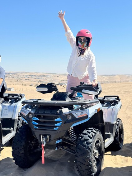A person on an ATV in a desert landscape. 1
