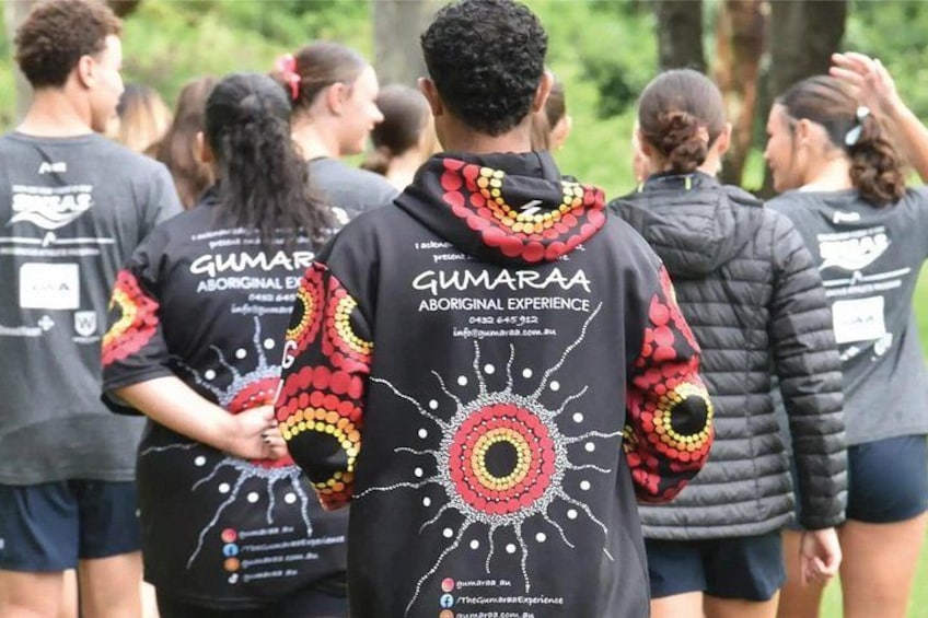 People wearing black shirts with colorful designs and text. 3