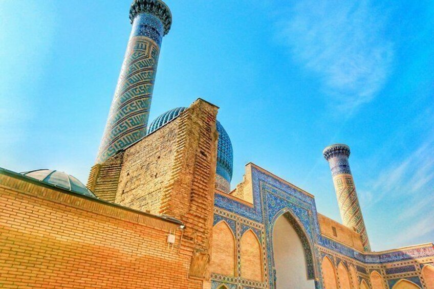 A mosque with blue-tiled minarets and a dome. 3