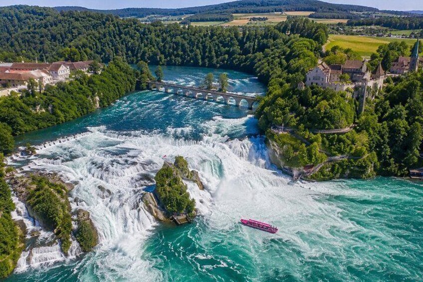 A river with a waterfall, a bridge, and a boat. 1