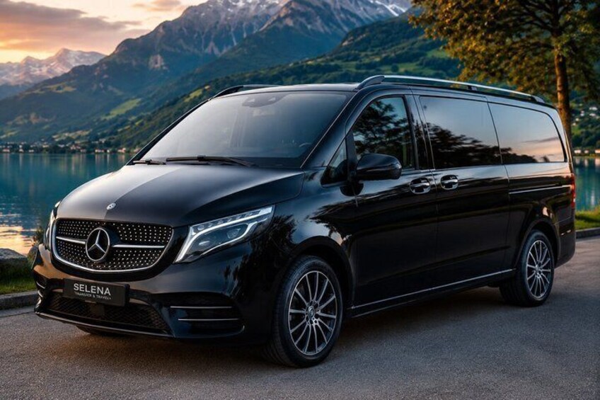 A black Mercedes-Benz SELENA van parked on a road with a lake and mountains in the background. 4