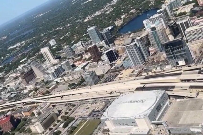 A cityscape with high-rise buildings, a bridge, and a stadium. 2