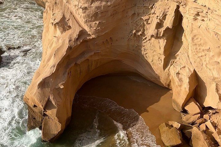 A large rock formation with a cave-like opening. 4