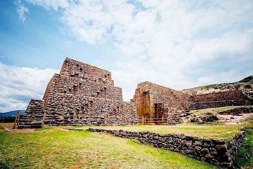 Ancient stone ruins with a large pyramid-like structure and a smaller building. 1