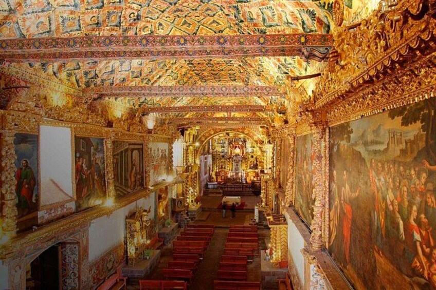 An ornate temple interior with detailed murals, golden decorations, and a central altar. 3
