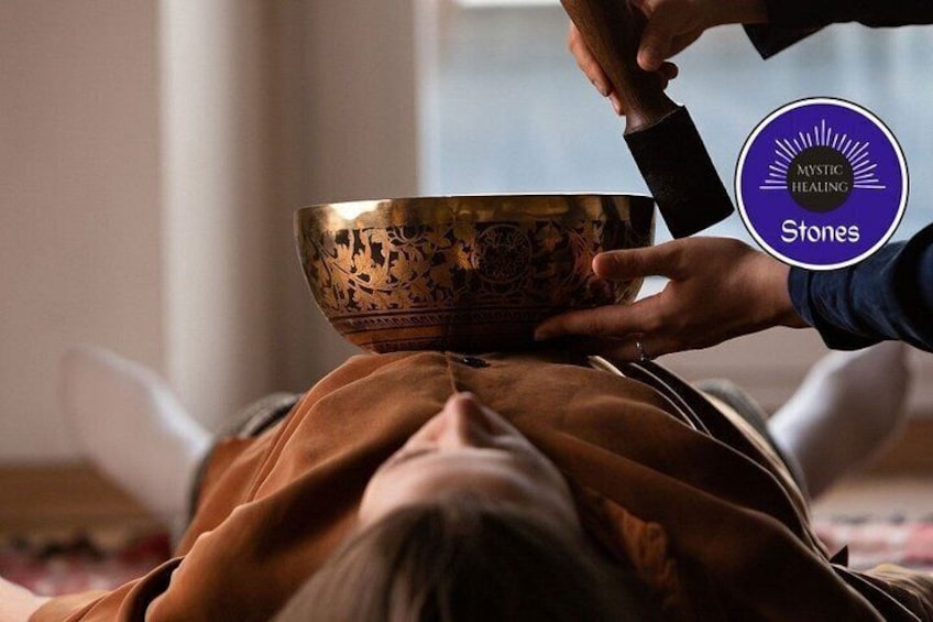 A person lying down with a large, ornate bowl in front of them. 3
