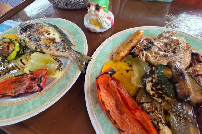 Two plates of grilled food with vegetables and meat. 3