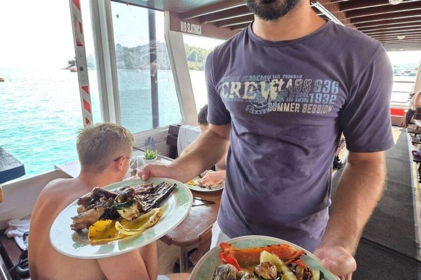 A person serving food on a boat. 4
