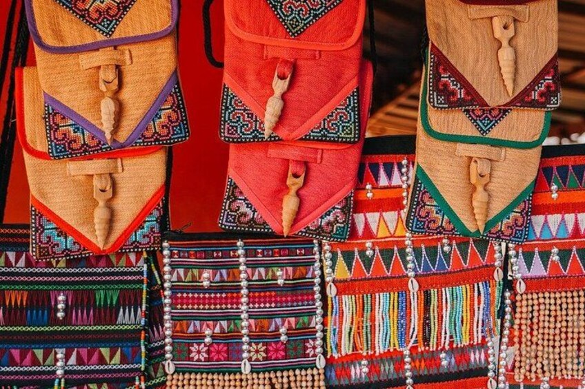 A collection of colorful woven textiles with intricate patterns and beadwork. 5