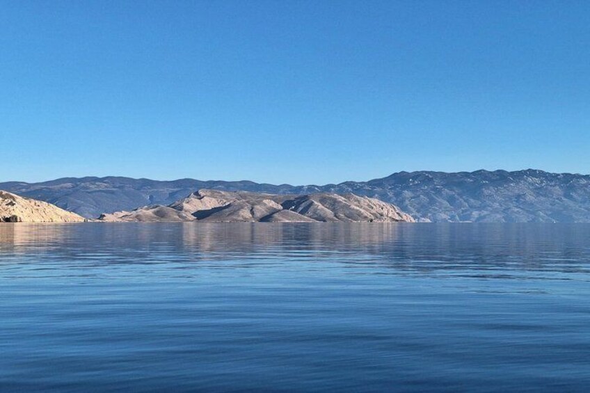A calm lake with mountains in the background. 2
