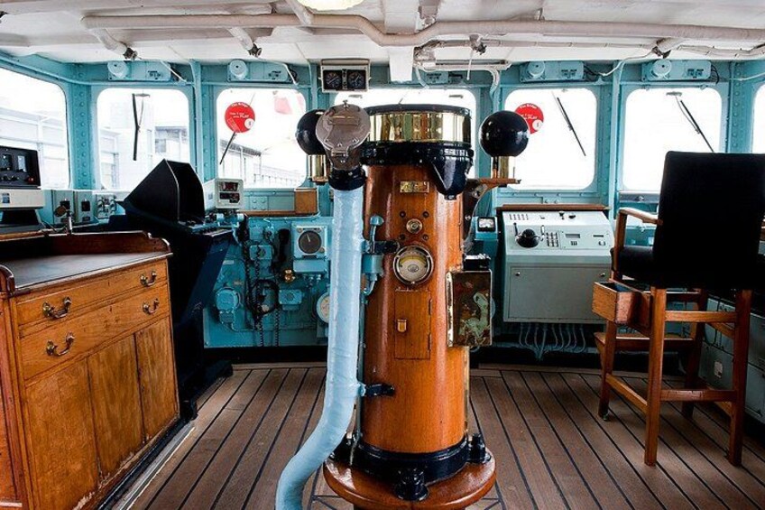 A vintage ship's wheel, wooden cabinets, and a steering wheel. 5