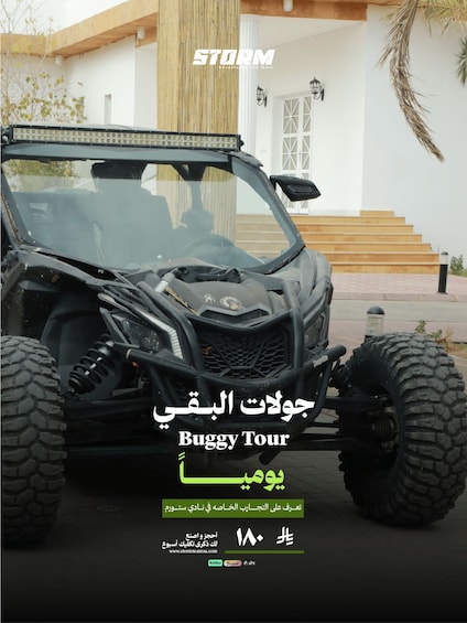 A black off-road vehicle parked in front of a white building with a staircase. 5