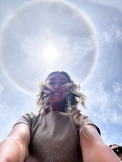 A person with a halo effect around their head, possibly due to sunlight or a lens flare. 4