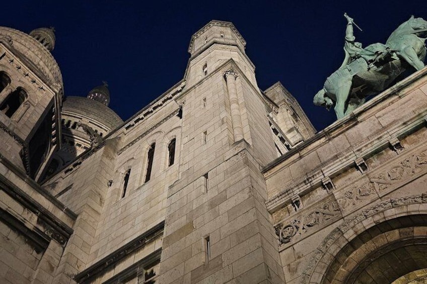 A historic building with domed architecture and a statue of a figure on horseback. 5