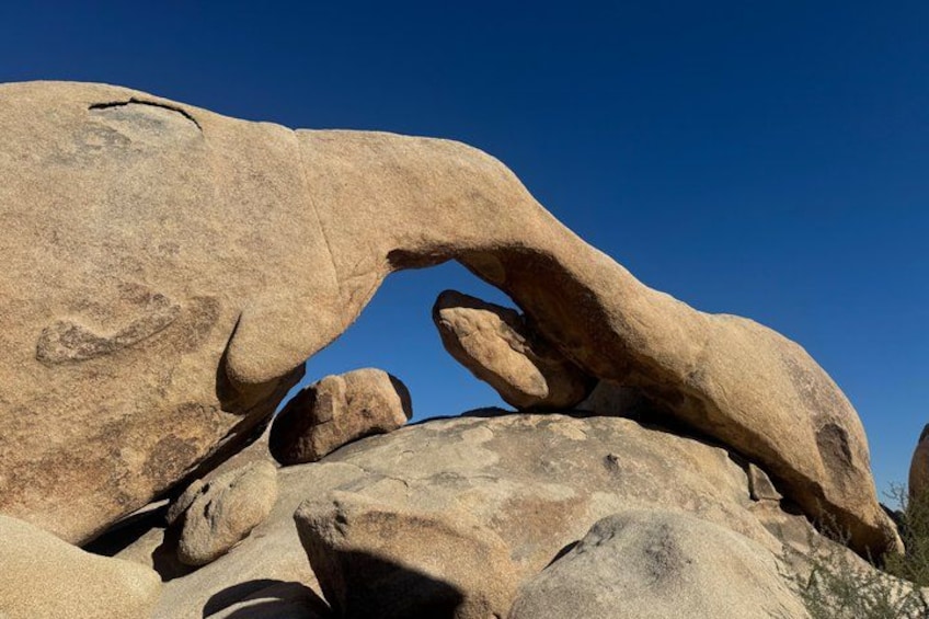 A large rock formation with a natural arch. 4