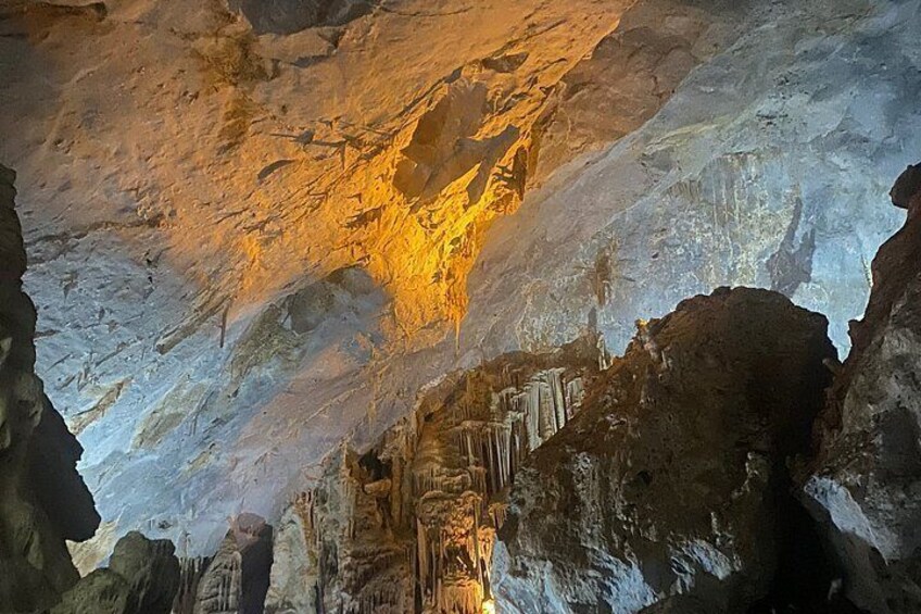 A cave interior with stalactites and stalagmites. 3