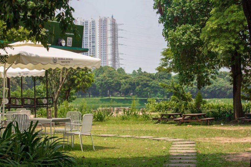 A park with a gazebo, picnic tables, and a view of a lake. 2