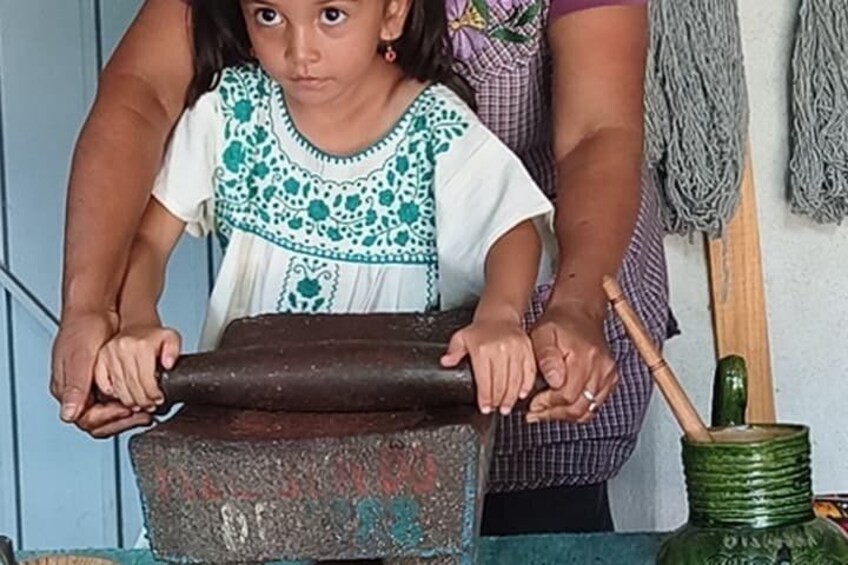 A person rolling dough on a surface. 5