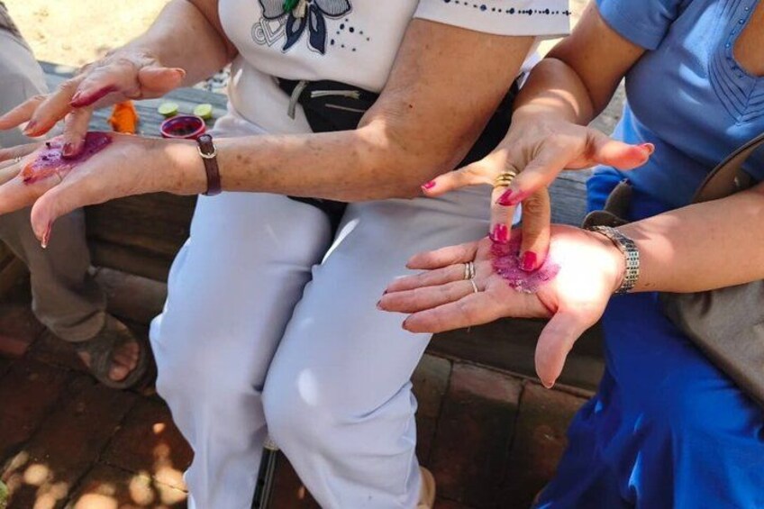 A person with colorful nail polish and a white shirt with a graphic design. 3