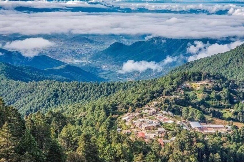A mountainous landscape with a town nestled among the hills. 2