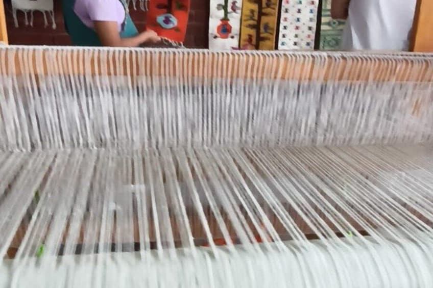 A weaving loom with threads in motion. 2