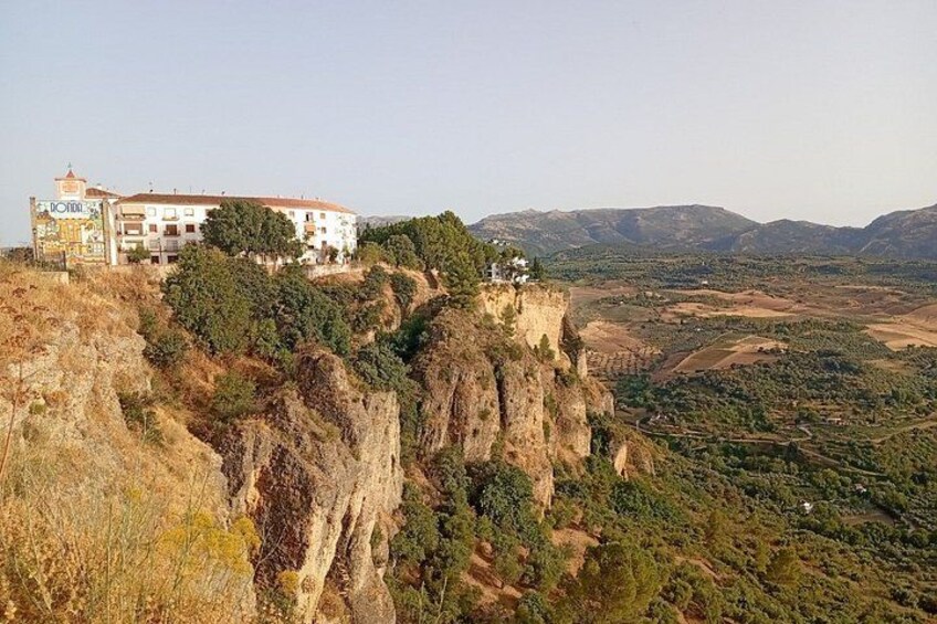 A building on a cliff overlooking a valley. 4