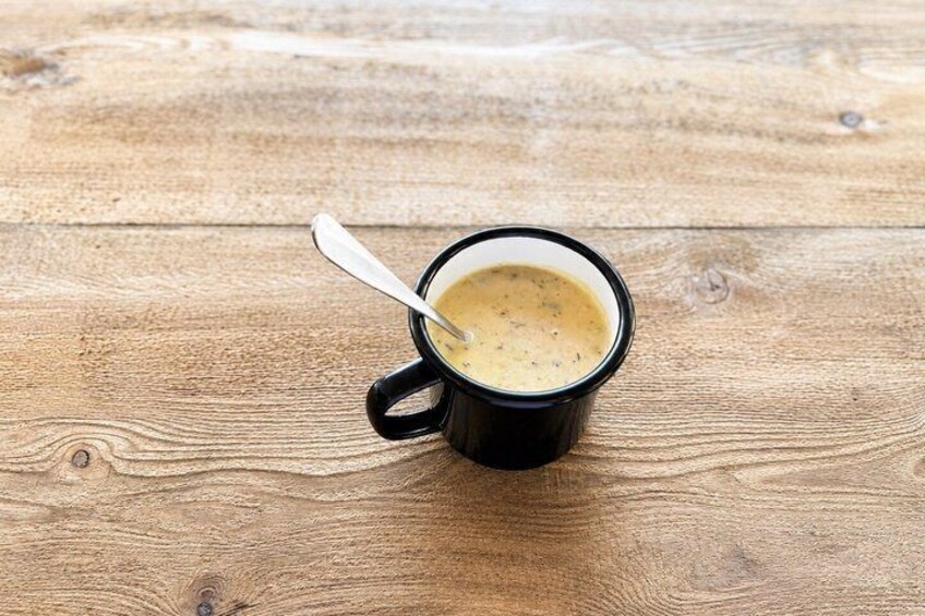 A black mug with a spoon on a wooden table. 3