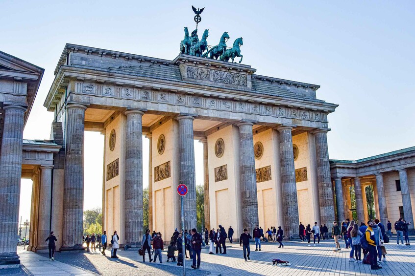 The Brandenburg Gate with tourists around. 1