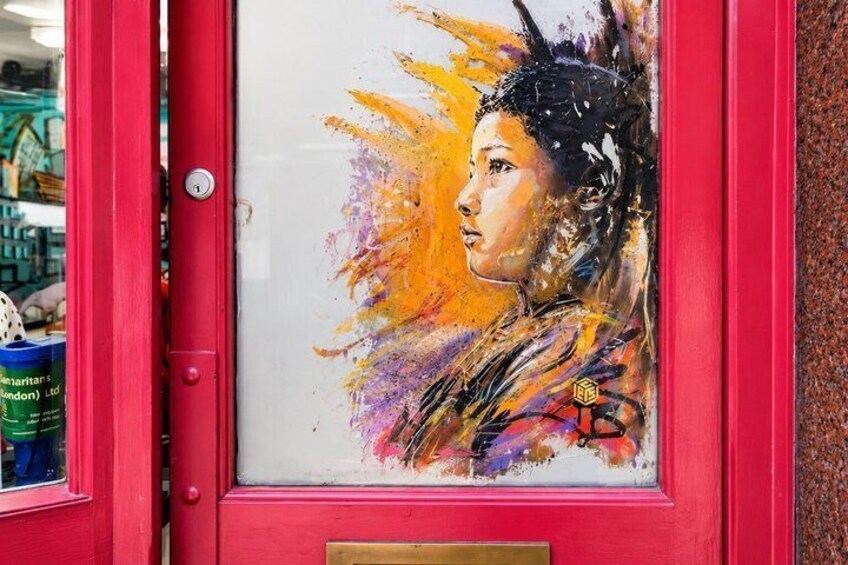 A red door with a colorful abstract painting on it. 5