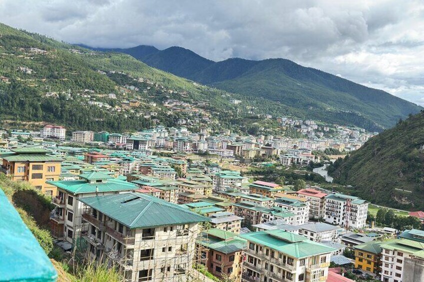 A mountainous town with colorful buildings and a river. 5