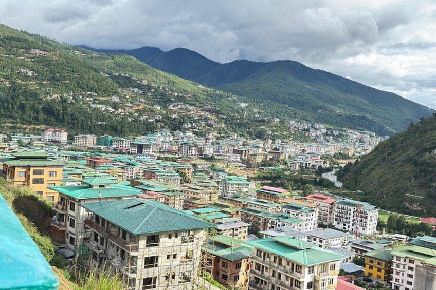 A mountainous town with colorful buildings and a river. 5