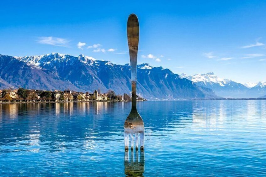 A fork in water with mountains in the background. 1
