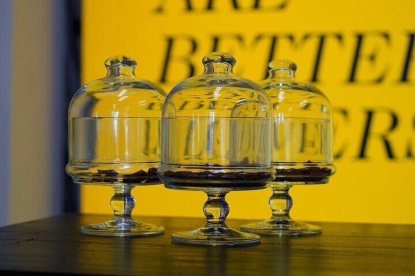 Three glass-covered containers on a wooden surface with a yellow background and the text "ARE BETTER". 2